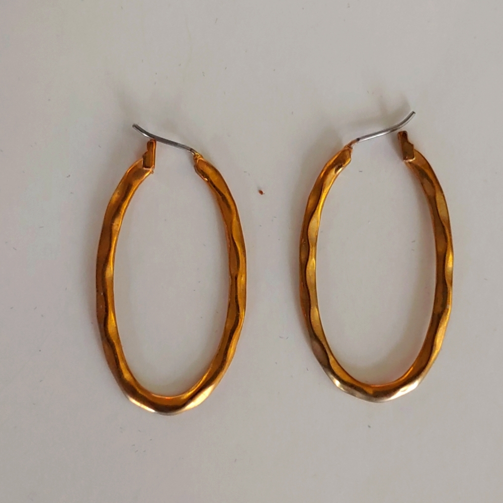 Gold oval loop earrings with hammered detail